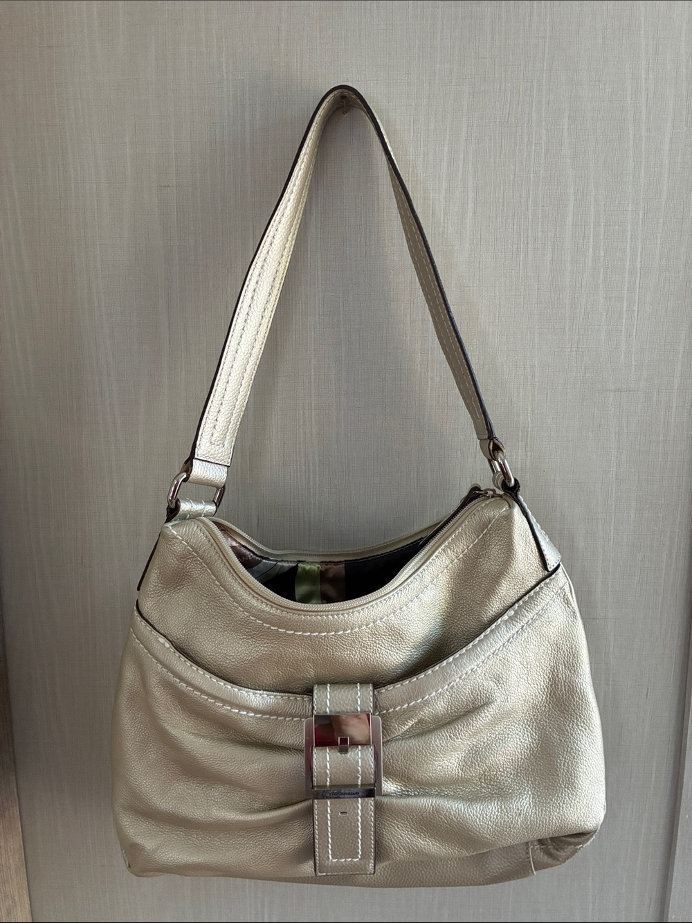 Tignanello Metallic Silver Shoulder Bag Buckle Accent Zip Closure
Inner Pockets